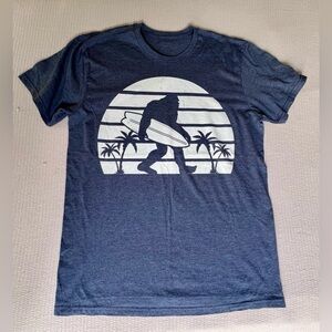Surfer T-shirt. Soft with cute decal of a Yeti or Big Foot carrying surfboard.